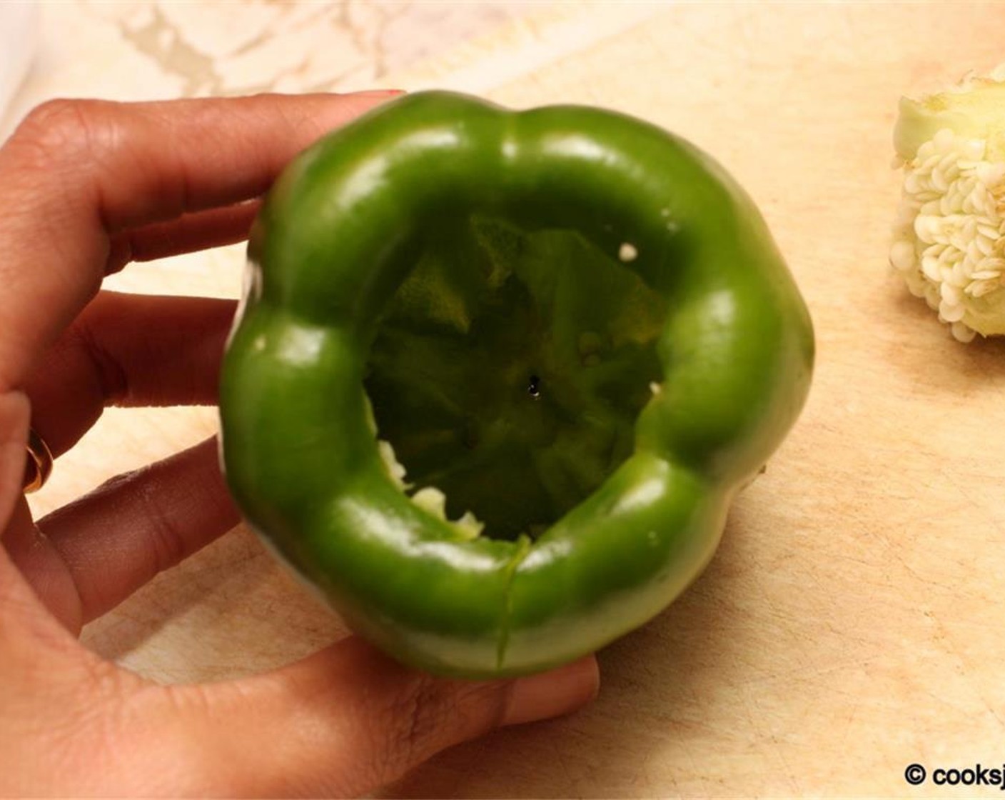 step 4 Take each Green Bell Peppers (9) and remove the top portion. Remove the seeds from the inside. Place the cleaned peppers in boiling water for about 7 minutes. Flip once in the middle if the peppers are not fully submerged in water.