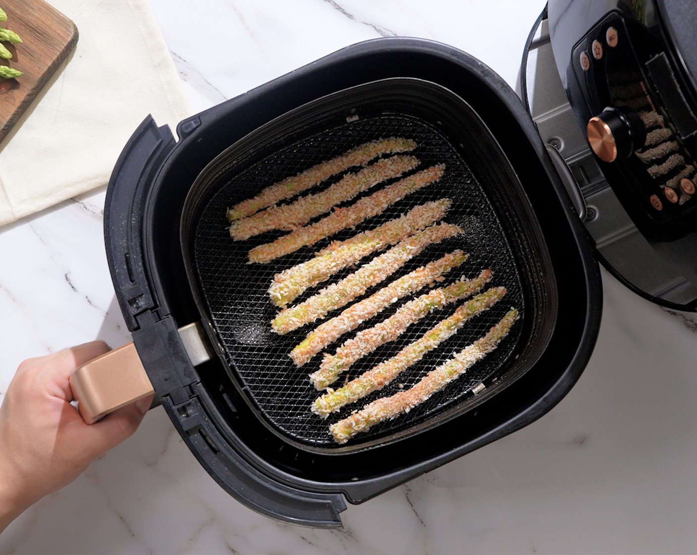 step 6 Spray the air fryer basket with Nonstick Cooking Spray (as needed). Place the asparagus in a single layer and air fry at 400 degrees F (200 degrees C) for 7-10 minutes until golden brown. Repeat with the other batches.