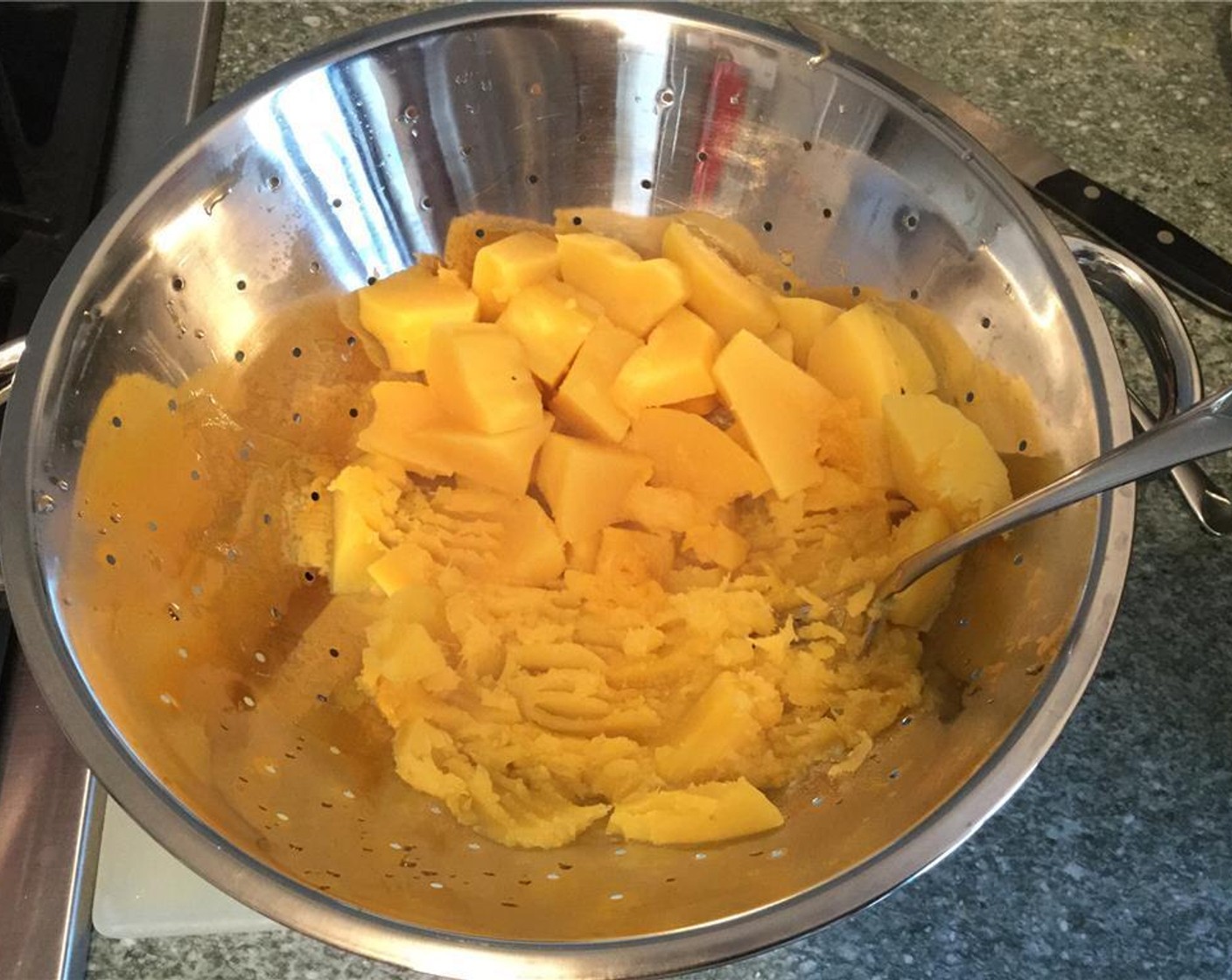 step 5 Drain the water and smash the squash pieces with a fork.