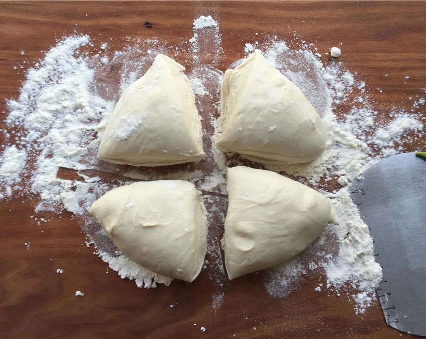 step 9 Take the Pizza Dough (1 lb) out of the fridge. Place it on a lightly floured surface. Using a bench scraper or knife, divide the dough into four equal pieces.