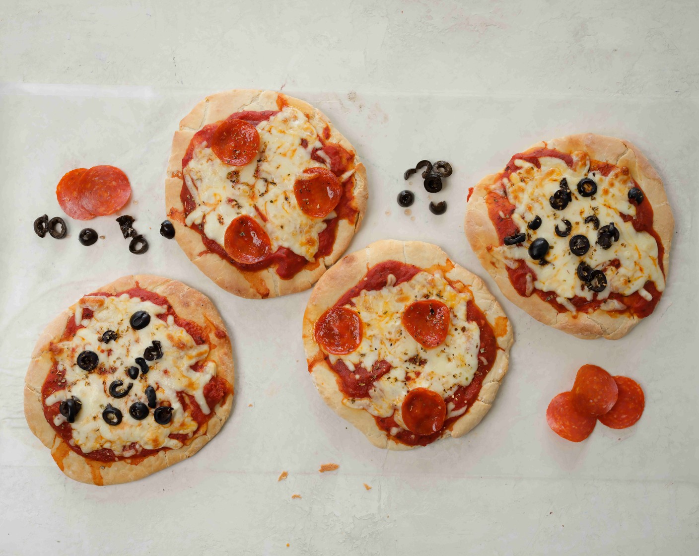 step 6 Return the pizzas to the oven and bake for 6 to 8 minutes until the cheese is melted and bubbly and the pizza crust has browned.