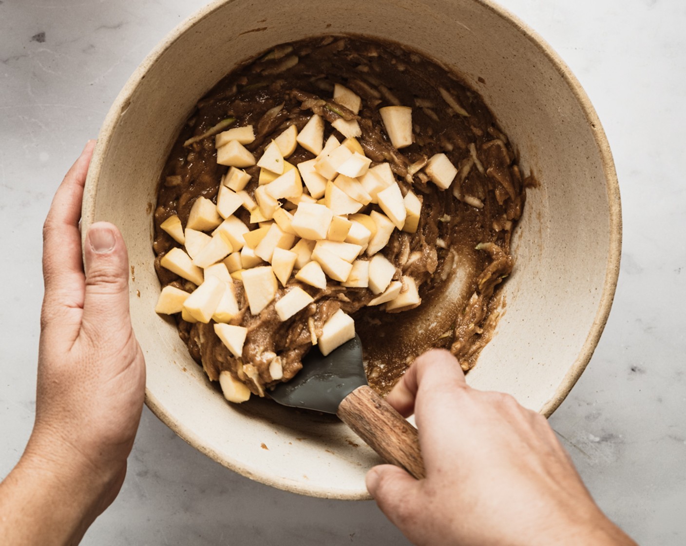 step 4 With a spatula, stir flour mixture into the wet mixture. Fold in the grated Apples (2) and then fold in chopped apples. Scrape batter into the prepared pan and smooth the top.