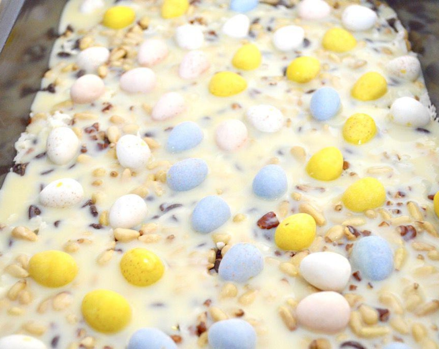 step 4 Once soaked, sprinkle the Cadbury Mini Easter Egg Candy (1 cup) all over the top and gently press them into the sweetened condensed milk so that they stay put.