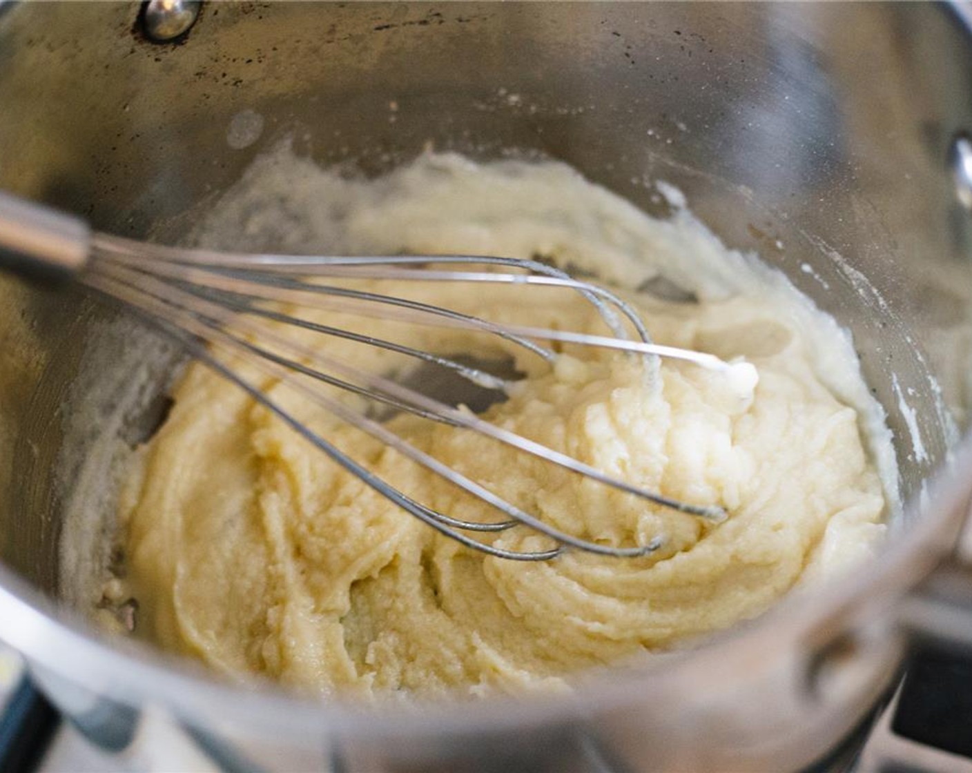 step 5 Continue to add milk and cook until the mixture forms a paste, about ten minutes.