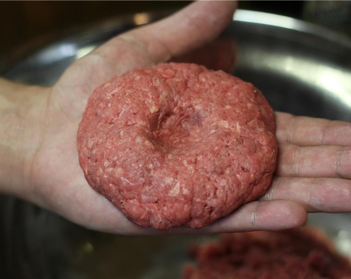step 8 Divide the 80/20 Lean Ground Beef (4 lb) and form eight equal patties. Make sure to press and indent into the middle of the patty. This will make sure it cooks evenly.