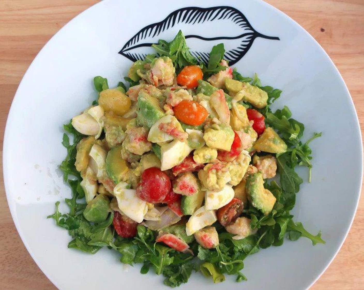 step 4 Plate the arugula first. Combine the rest of the ingredients, and add on top.