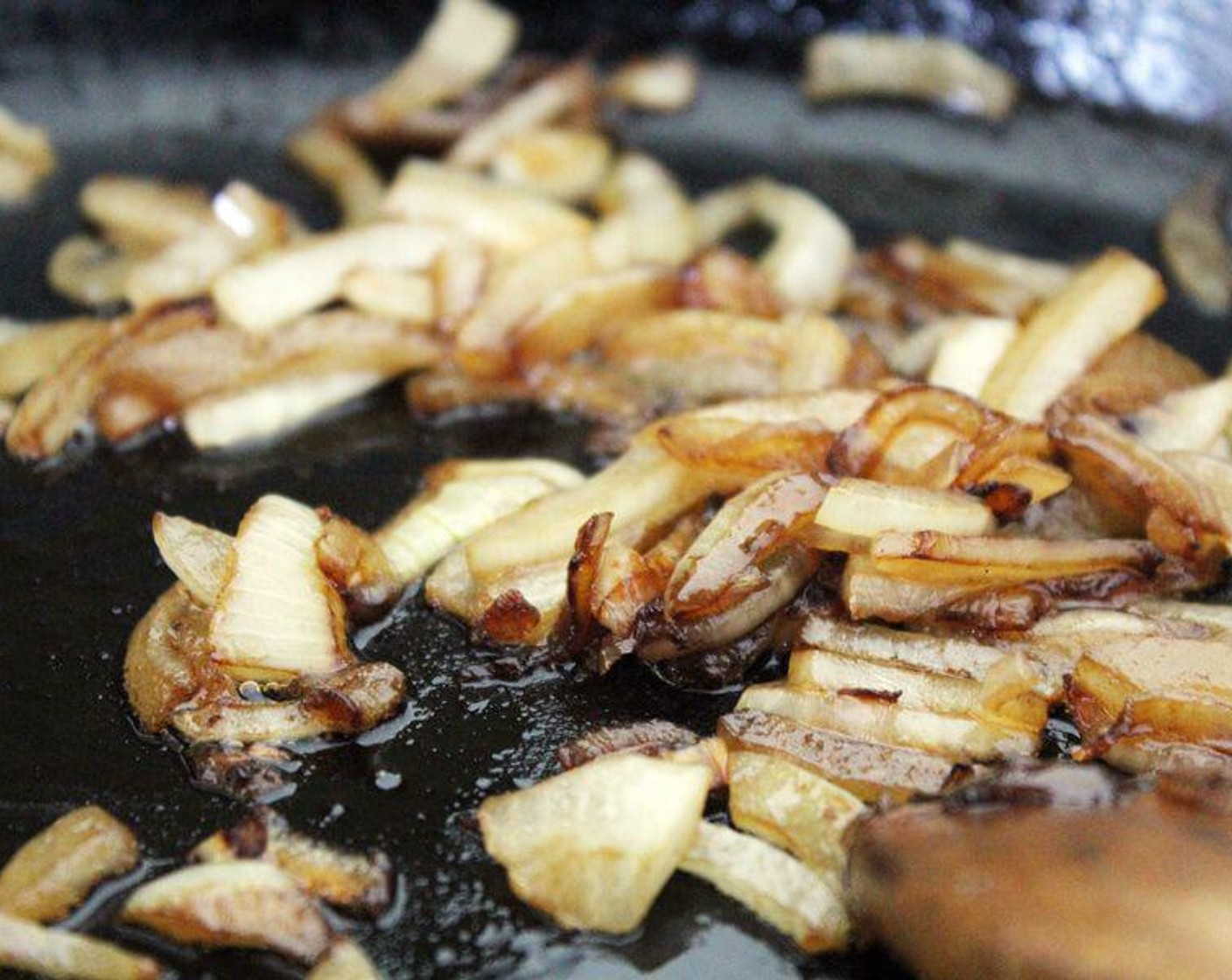 step 3 In the same skillet, slowly cook the Onion (1) in the remaining butter until soft and caramelized.