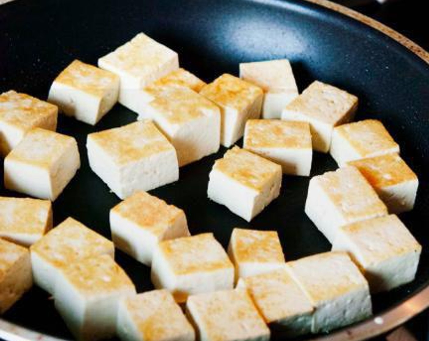 step 3 In a skillet heat up Vegetable Oil (1 tsp) and Sesame Oil (1 tsp). When warm, add the tofu and cook it on all 4 sides, season with salt and Chili Powder (1/2 tsp). Add the Soy Sauce (1 Tbsp) and saute for 1 min.