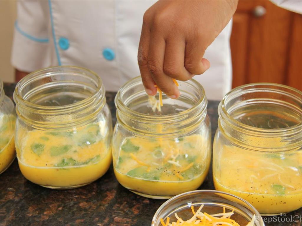 Step 3 of Protein Packed Breakfast in a Jar Recipe: Pour the egg mixture in the mason jars then sprinkle cheese in each jar.