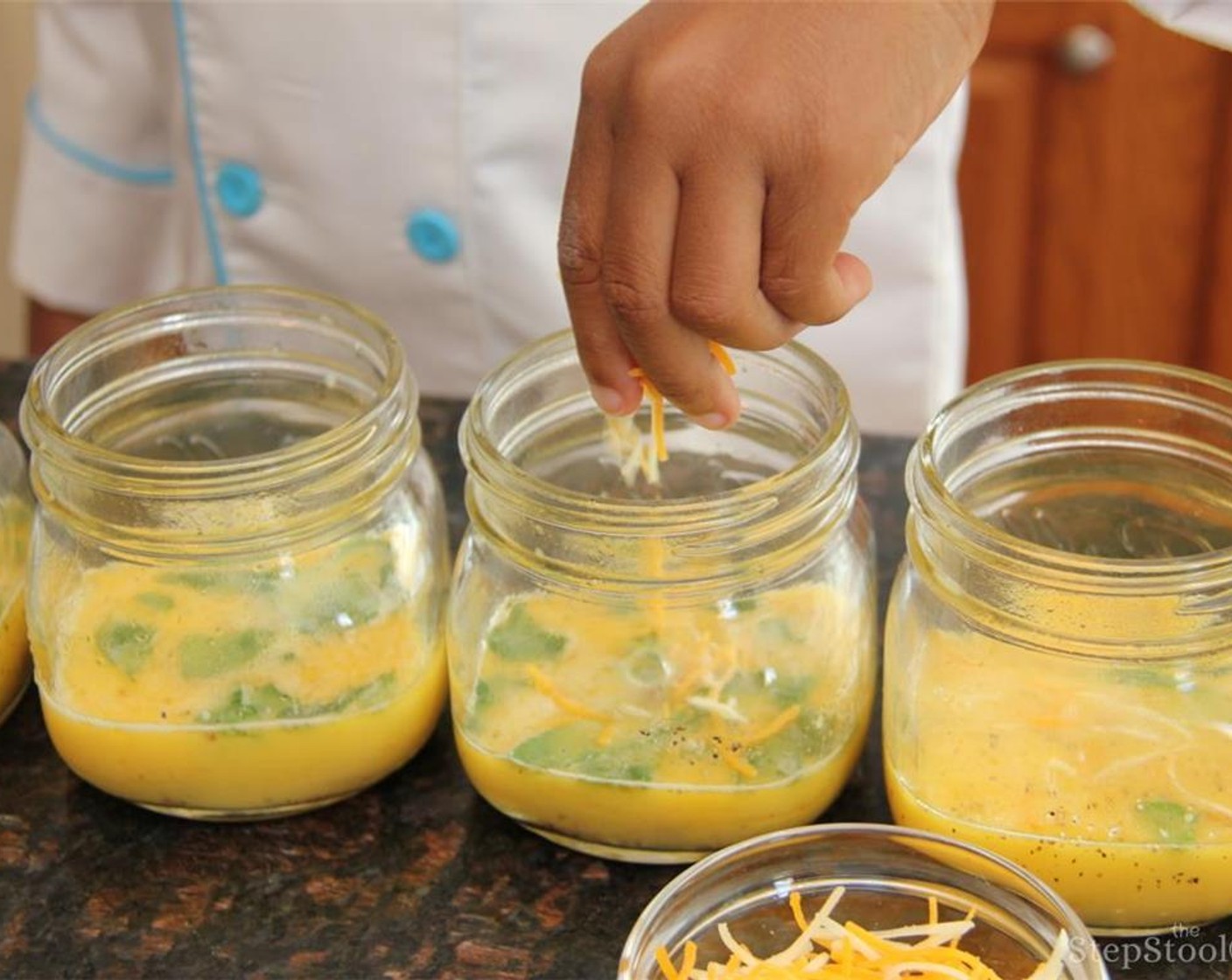 step 3 Pour the egg mixture in the mason jars then sprinkle cheese in each jar.
