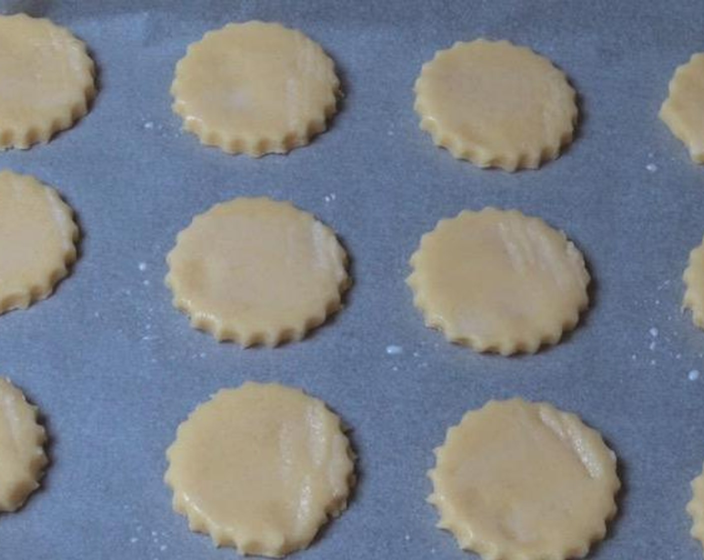 step 5 Using a fluted cookie cutter, cut out rounds from the dough. Brush the top of each with Milk (to taste).