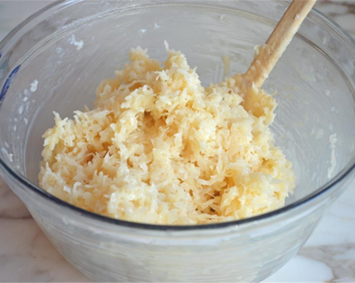 step 2 In a medium bowl, mix together the Sweetened Shredded Coconut (5 1/3 cups), Sweetened Condensed Milk (3/4 cup), and Vanilla Extract (1 tsp). Set aside.