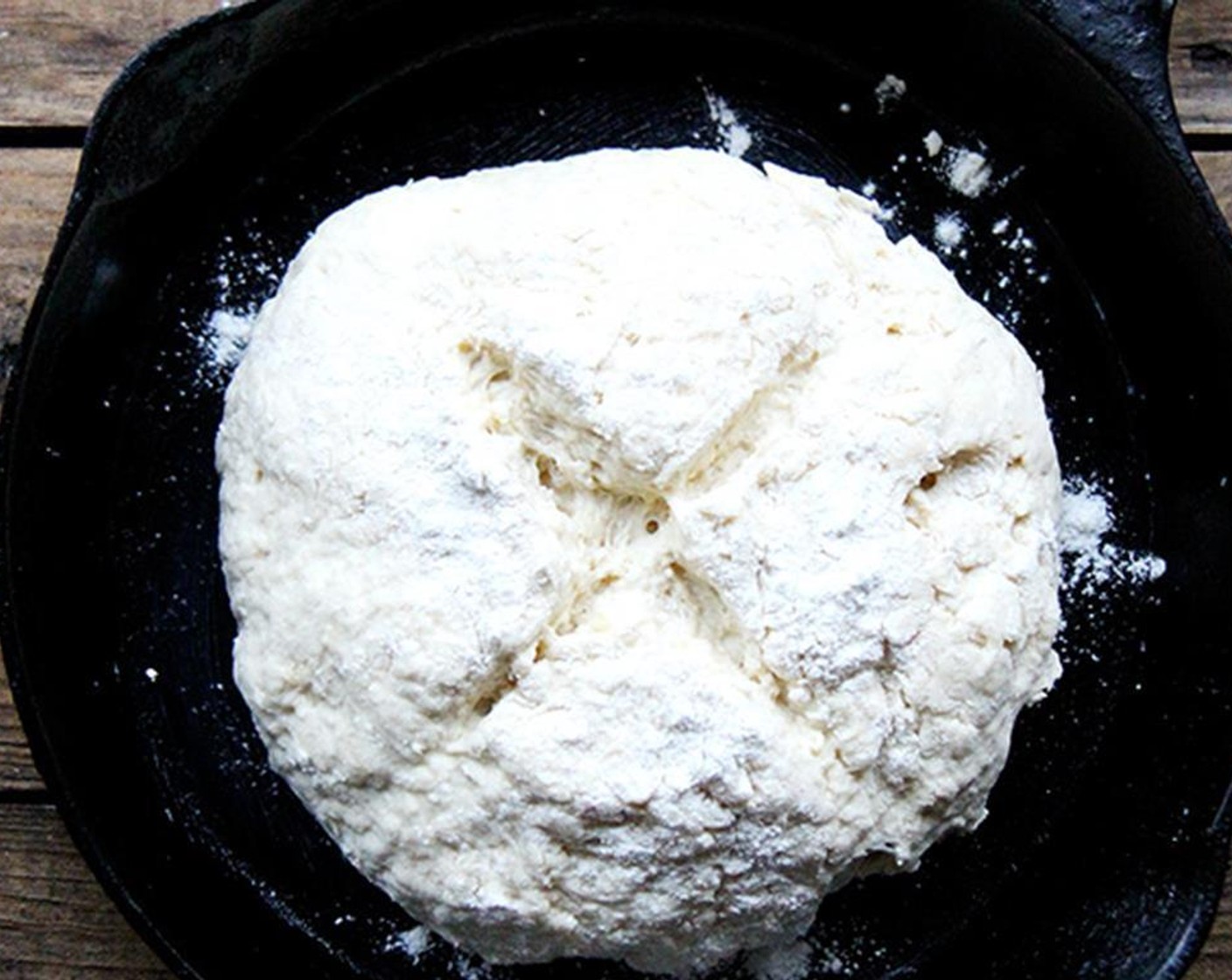 step 5 Lightly flour your hands and sprinkle a little flour over the sticky dough ball. use your hands to scrape the dough from the sides of the bowl and to quickly shape the mass into a ball, kneading lightly if necessary. Transfer to prepared skillet.