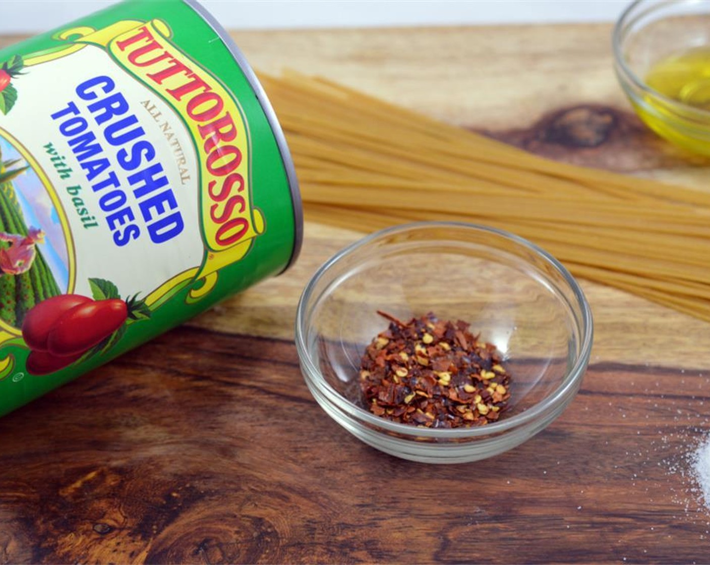 step 4 Add in can of Canned Crushed Tomatoes (3 1/3 cups), Crushed Red Pepper Flakes (1/4 tsp) and Granulated Sugar (1/2 tsp). Cook for 5 more minutes simmering lightly.