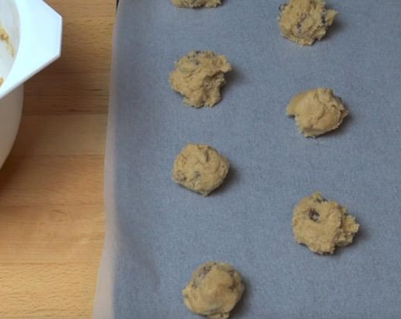 step 4 Place small spoonfuls of the dough, rolled into balls, onto baking trays lined with non-stick baking paper.