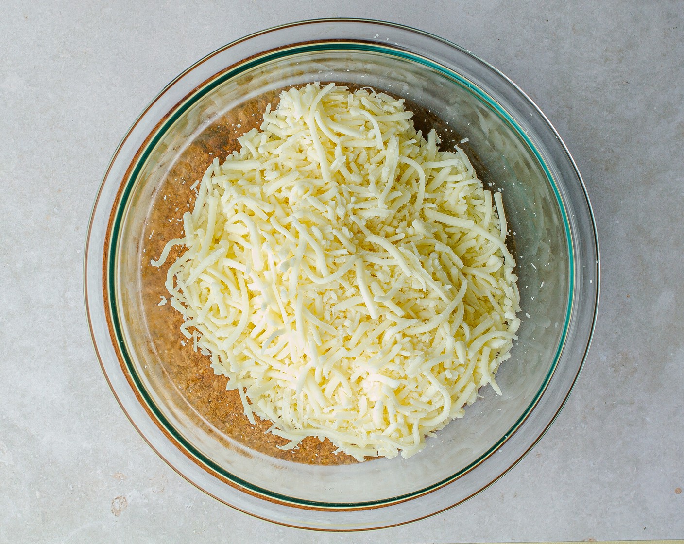step 3 Reserve ¼ cup of the Yellow Onion (1) and Green Bell Pepper (1) to the side for topping. Add Shredded Mozzarella Cheese (2 cups) and Shredded Parmesan Cheese (1/2 cup) to a bowl and toss to combine. Set aside.