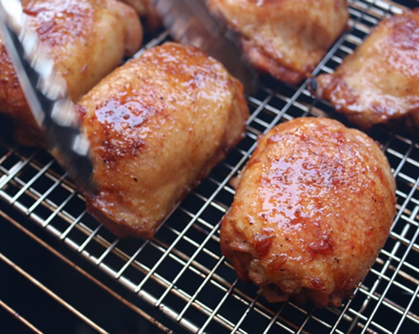 step 10 Dunk each thigh in the glaze and place on a wire rack, then place the rack directly on the cooking grate and cook for 10 minutes.