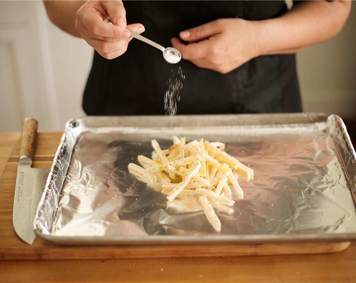 step 6 Cut Pita Bread (1) in half and slice across 1/4 inch thin to make strips. Place on baking sheet lined with foil. Sprinkle with Olive Oil, Salt (1/4 tsp), Ground Black Pepper (1 pinch) and toss. Spread out on a single layer. Bake for 5 minutes.