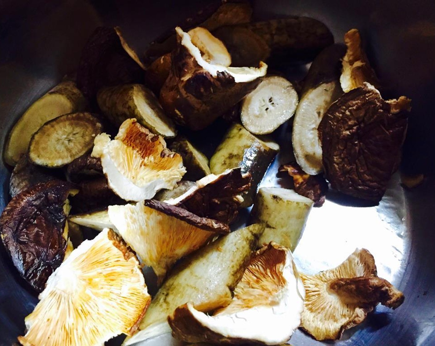 step 8 Turn heat on to medium, and add Vegetable Oil (1 Tbsp) to the pressure cooker. Put in gobo and shiitake mushrooms and stir for about two minutes.