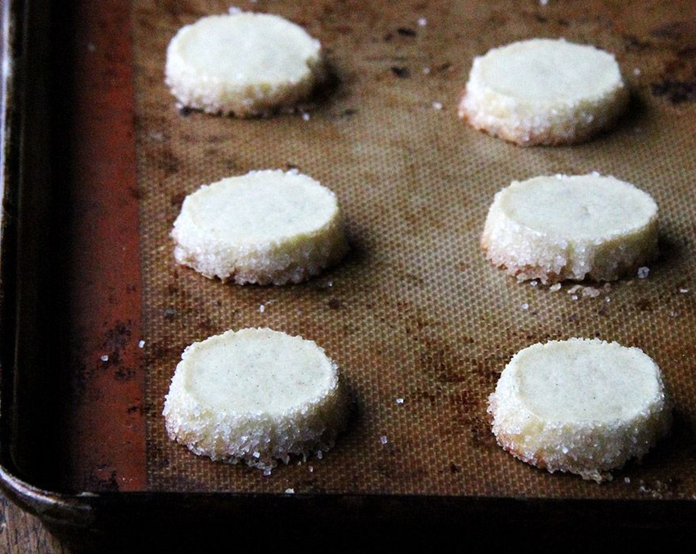 step 6 Using a sturdy knife, trim the ends of the logs if they’re ragged, then cut the dough into half-inch-thick rounds. Place as many cookies as will fit on the baking sheet, spacing them about two inches apart.