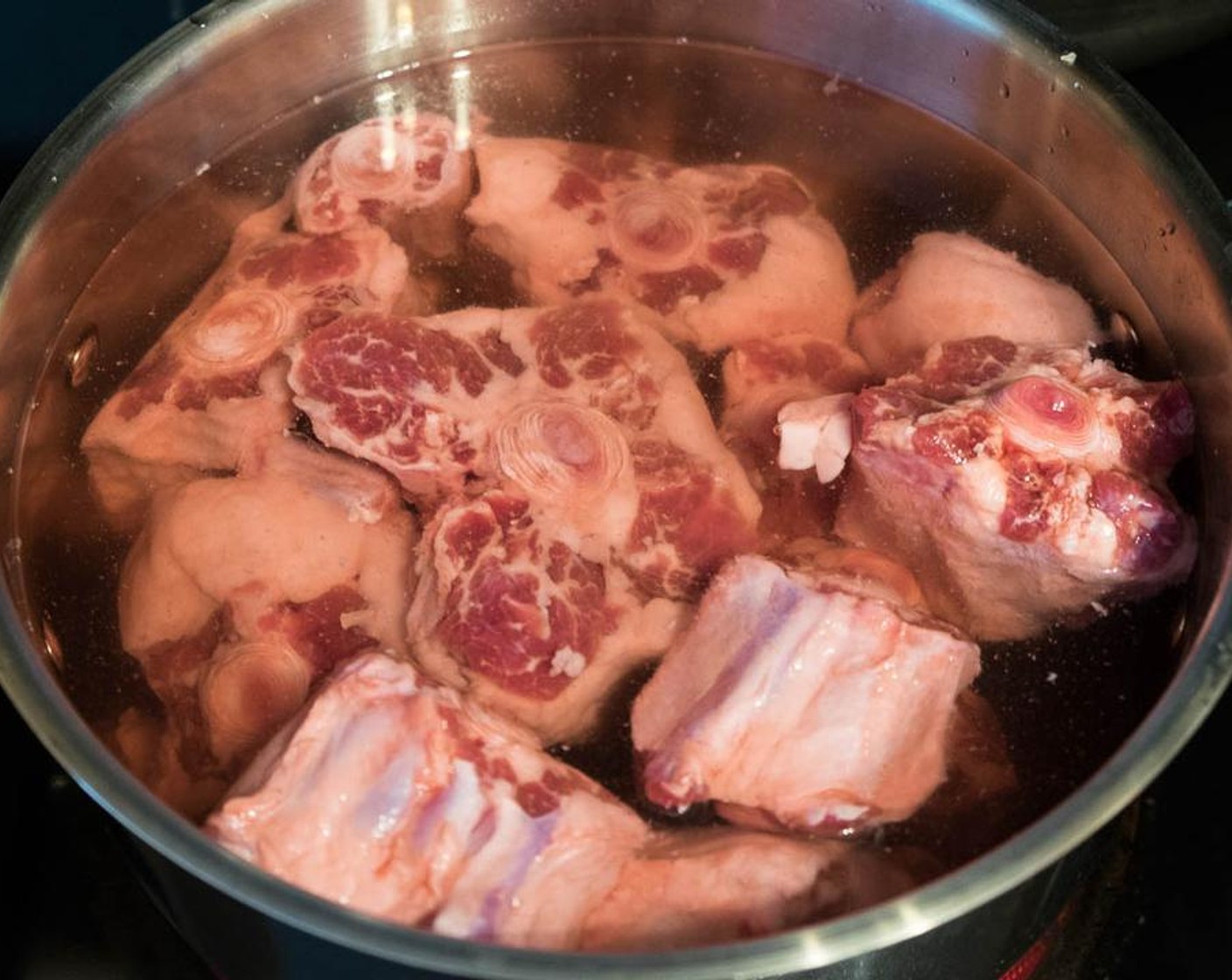 step 1 Add Oxtails (4.4 lb) and Beef Stock (8 cups) in a big pot. Cook over medium-high heat and bring to a boil. Turn to medium-low heat. Simmer for 20 to 30 minutes. Skim any brown foam from the top of liquid.