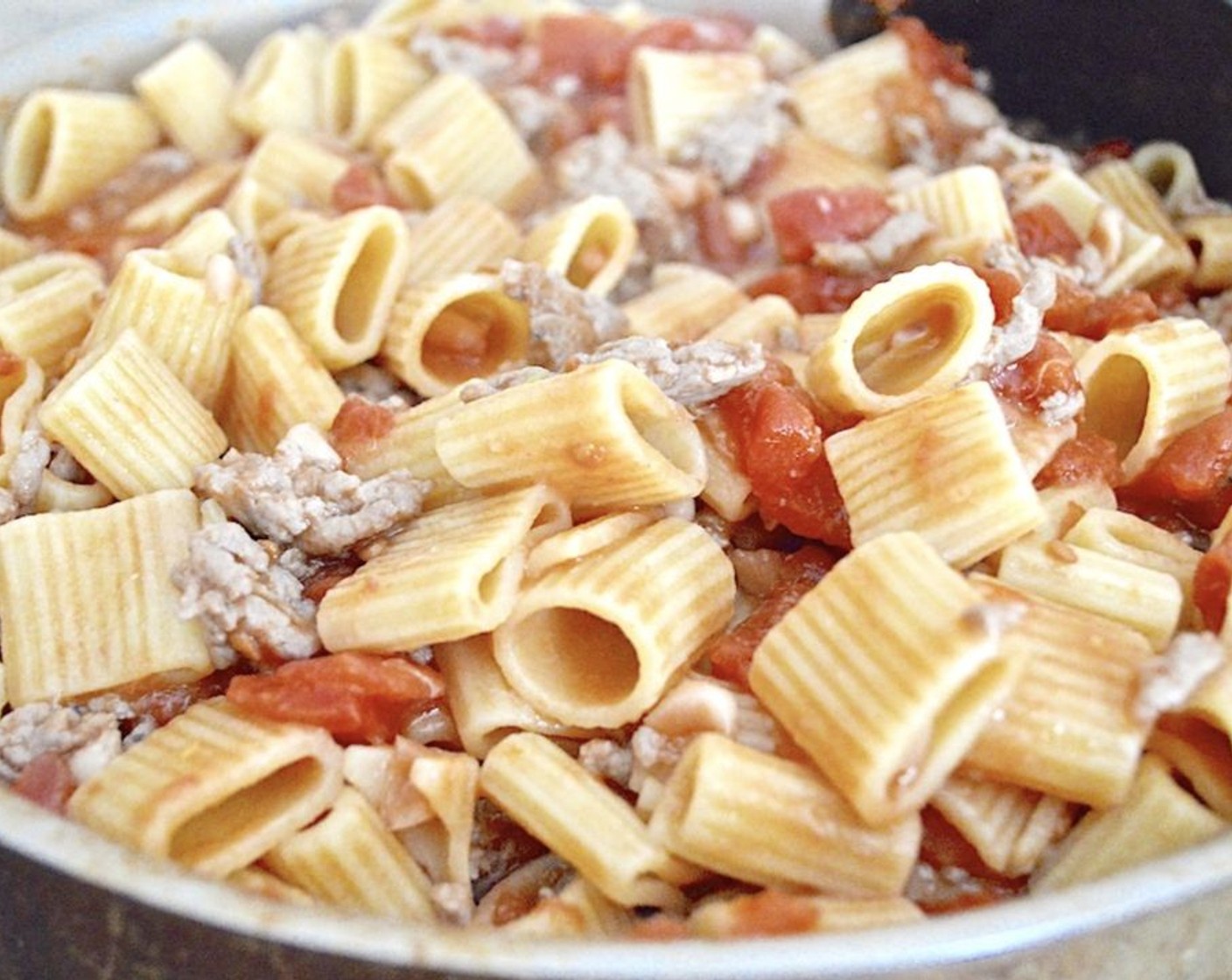 step 6 Toss the drained pasta into the big pan of sauce so that it absorbs some of the sauce as it bubbles together. Take it off the heat after 1 minute.