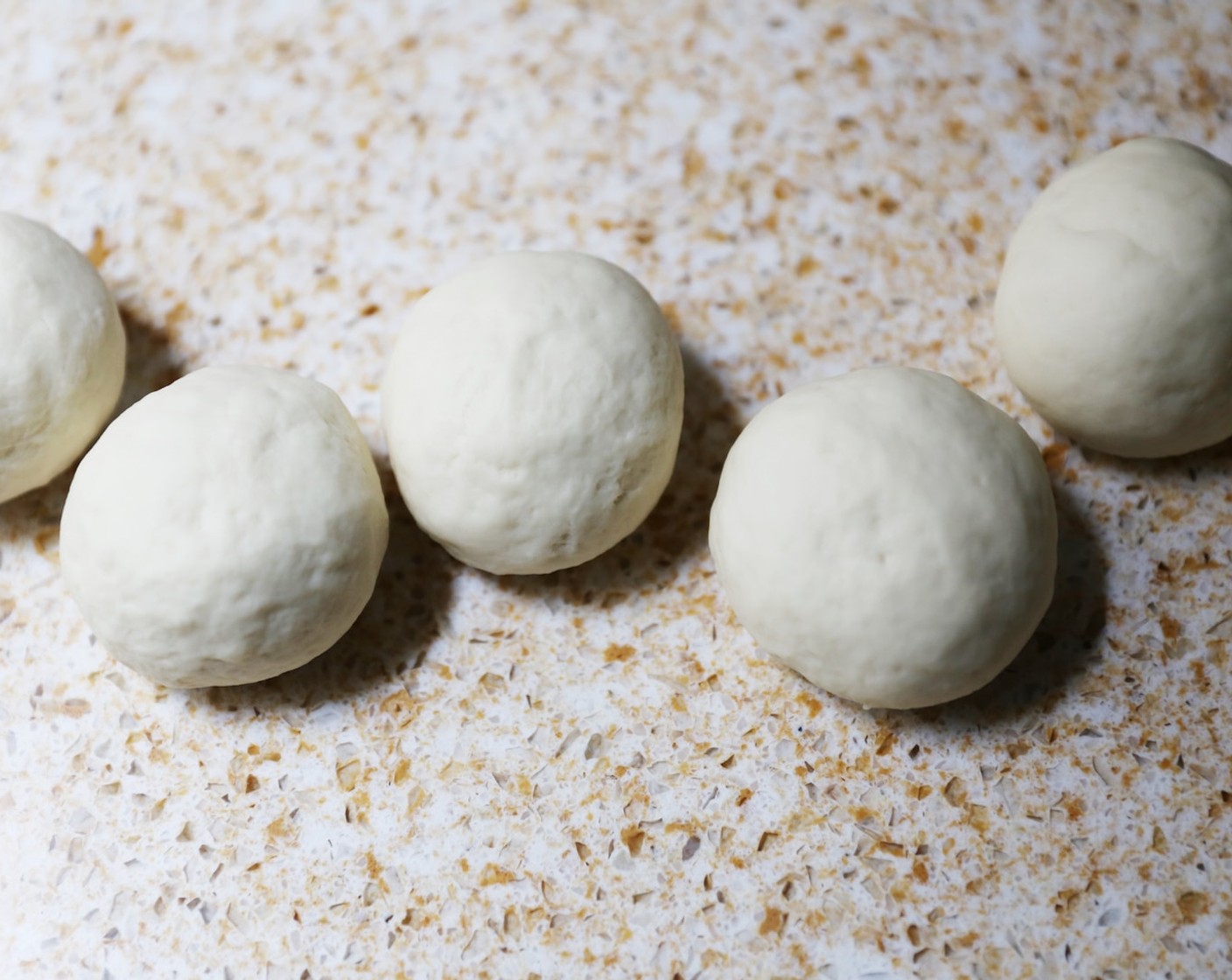 step 10 Roll each piece of dough into smooth balls and leave to rest for 2-3 minutes.