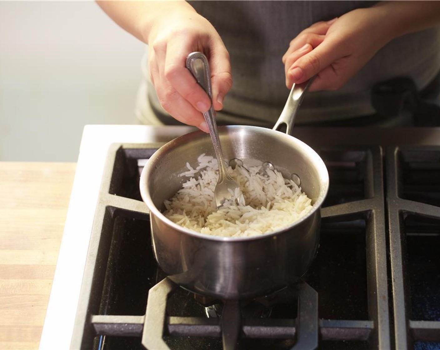 step 4 In a medium saucepan, add one cup of water and the Basmati Rice (2/3 cup). Bring to a boil over medium-high heat. Stir once, then cover and reduce heat to low and simmer for fifteen minutes. Remove from heat, fluff rice, and keep warm.