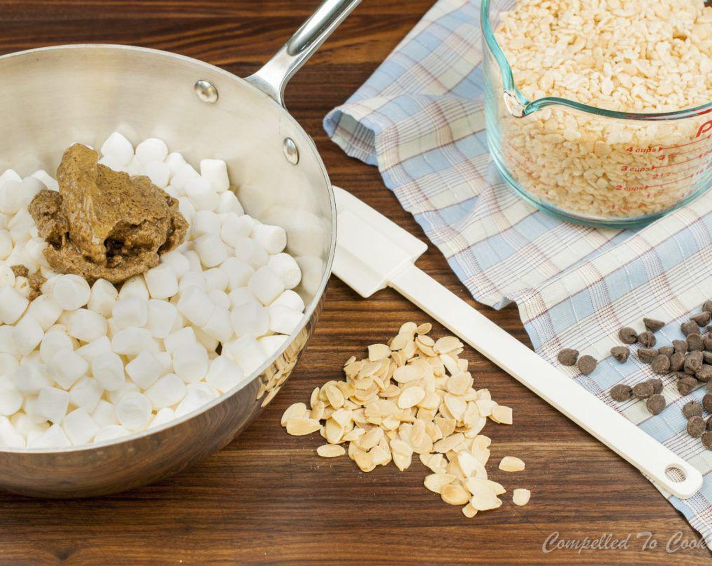 step 2 Using a large pot, melt Mini Marshmallows (8 cups) and Unsalted Butter (4 Tbsp) over medium heat until almost melted. Add Almond Butter (1/2 cup) and Almond Extract (1/4 tsp). Stir until smooth, removing from heat when the last of the marshmallows have melted.