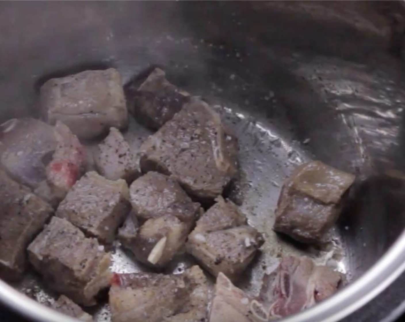 step 3 Add the Goat Shoulder (1.1 lb) into the pot. Add Kosher Salt (2 pinches) and Ground Black Pepper (2 pinches). Then, brown the goat shoulder on all sides for a total of roughly 5 minutes. Remove and set aside.