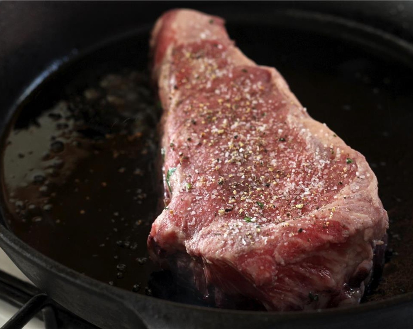 step 5 Season the steaks with Sea Salt (to taste) and Freshly Ground Black Pepper (to taste). In a heavy skillet, sear each of the steaks in Olive Oil (1 Tbsp), about 3 to 4 minutes on each side, in a smoking hot pan.