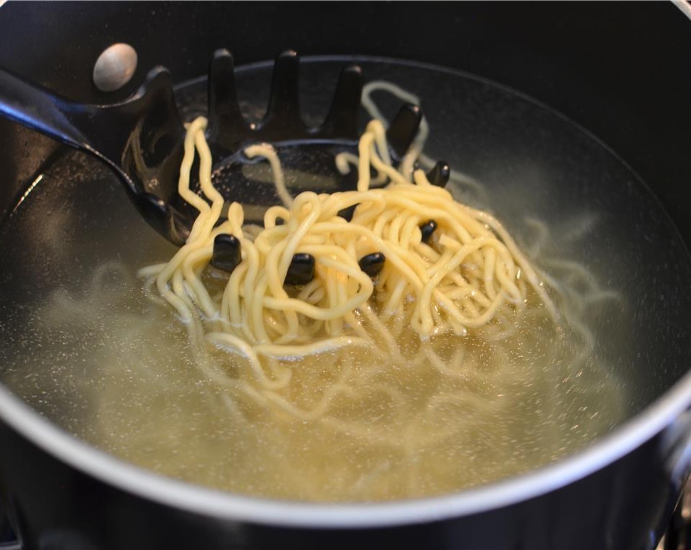 step 5 Discard the seasoning sauce packets from the Fresh Yakisoba Noodles (2 pckg) and add the noodles to a pot of boiling water to loosen them.