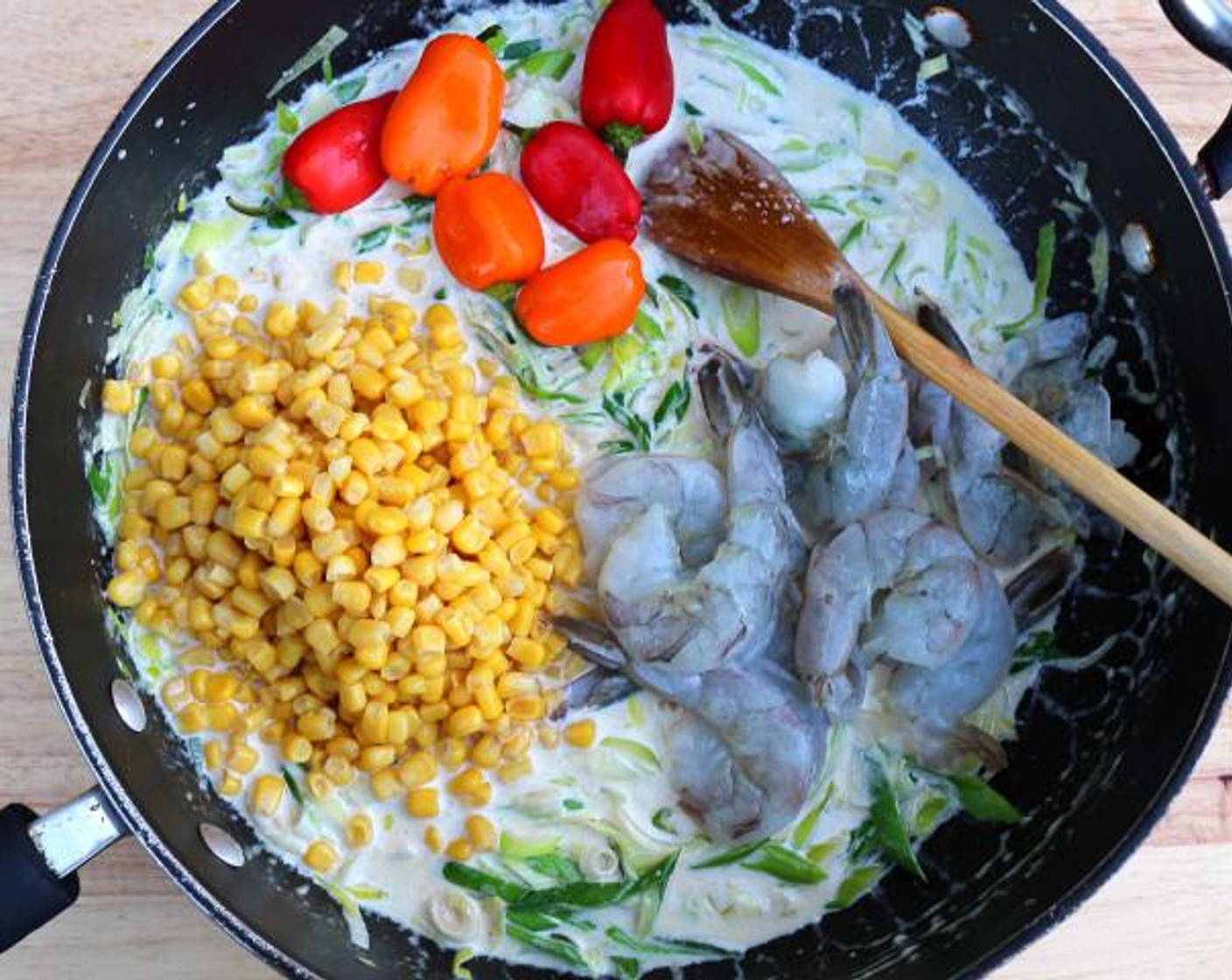 step 4 Add Whole Kernel Corn (1 cup), 6 Chili Peppers (6) and Large Shrimp (1 lb). Season with Kosher Salt (to taste) and Cayenne Pepper (to taste). Stir and cover the mixture, and simmer slowly until shrimp are just cooked through (2 to 4 minutes, depending on the size of the shrimp).