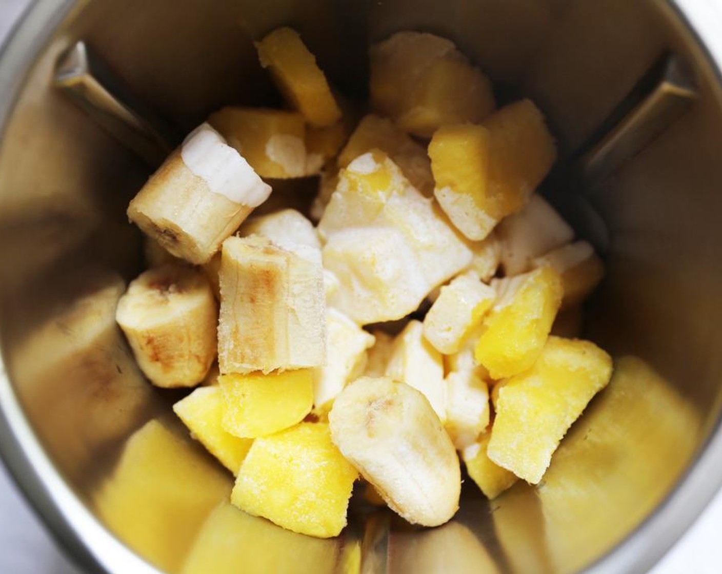 step 1 Place the Frozen Pineapples (4 cups), Banana (1) and Coconut Milk (1 cup) in the jug of a high-speed blender.