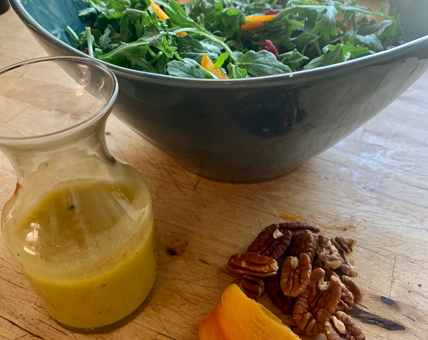 step 2 In a large bowl combine the Arugula (to taste), Dried Persimmons (to taste), Roasted Pecans (to taste), and Dried Cranberries (to taste). Drizzle with the dressing and enjoy.
