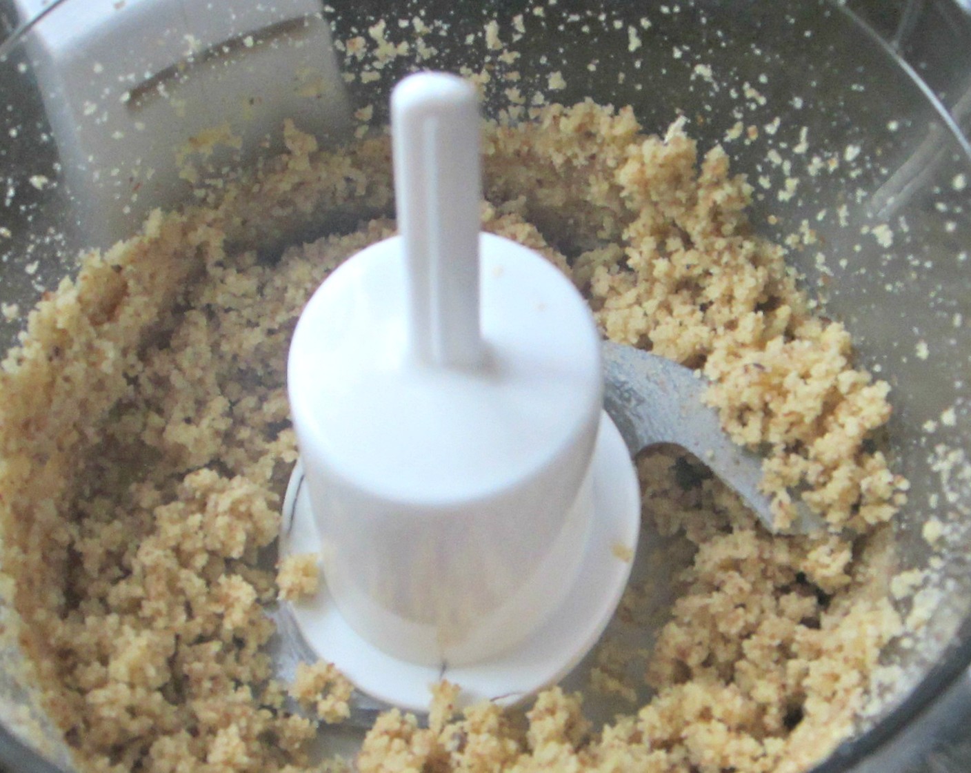 step 13 Scrape nuts from the sides of the food processor, add Maple Syrup (1/3 cup), Ground Cinnamon (1 Tbsp), melted Coconut Oil (1 Tbsp), Vanilla Extract (1 Tbsp), Brown Sugar (1 Tbsp) and Salt (to taste) and blend well.
