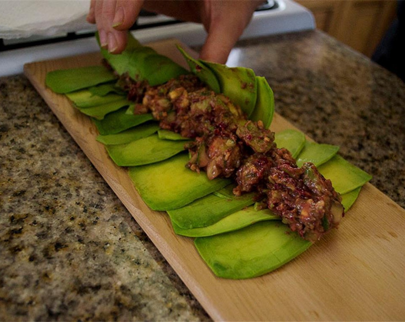 step 12 Put a little of the guacamole on the avocado slices and roll into a cigar.