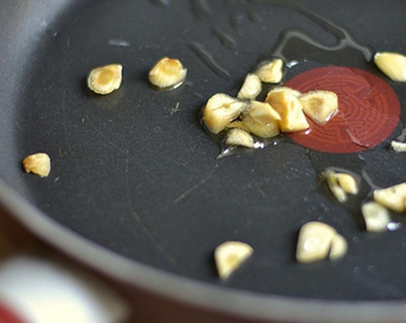 step 2 Chop the Garlic (5 cloves) and toss them into a hot pan. Add Extra-Virgin Olive Oil (1 Tbsp) and saute over medium heat for a minute until it starts to change color.