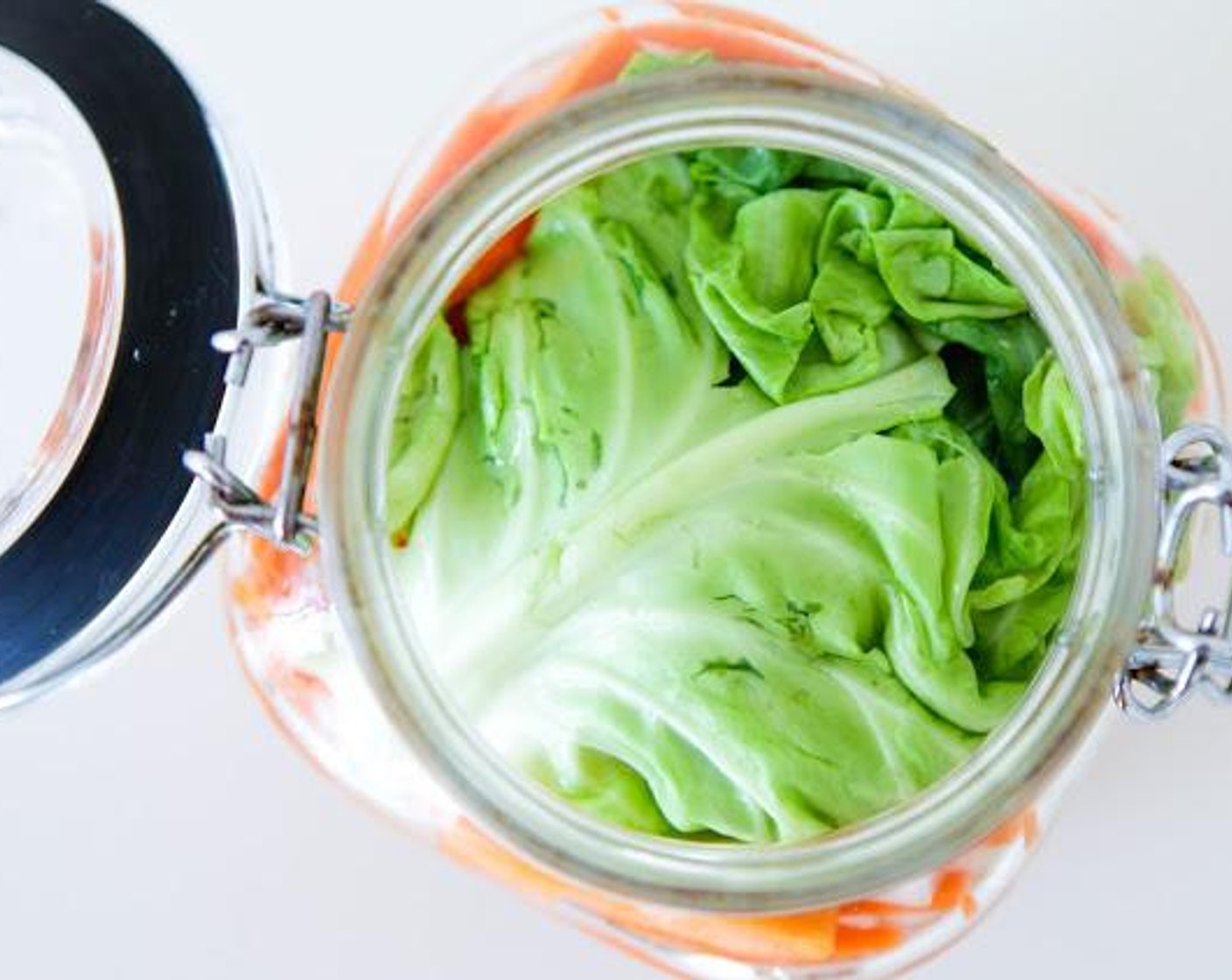 step 5 Add in enough Water (to taste) to just cover the vegetables once pushed down and compacted. Roll up the 2 outer leaves of the Green Cabbage (1 head) and push the vegetables down. This should bring the water level up to the top.