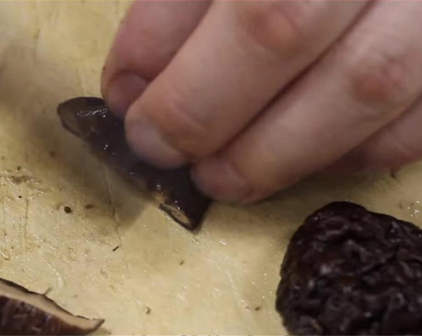 step 9 Slice the rehydrated shiitake mushrooms.