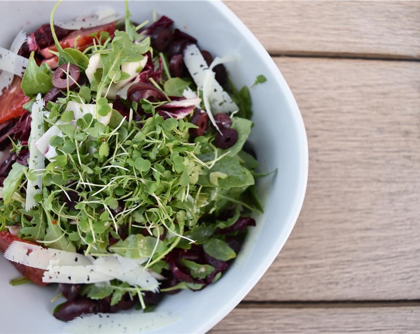 step 5 Assemble the salad: toss the radicchio, fennel, Wild Baby Arugula (1 pckg), and dressing together, top with the oranges, manchego, and olives, and give it a final toss.