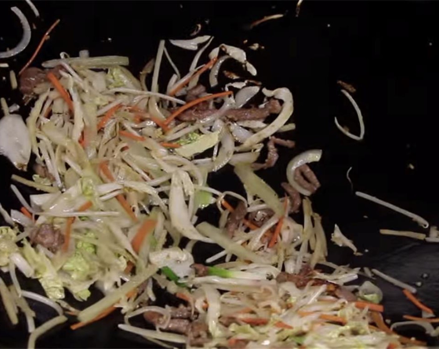 step 18 Add the carrots, celery, napa cabbage, bean sprouts, bamboo strips and the white part of the green onion. Stir fry for 30 seconds.