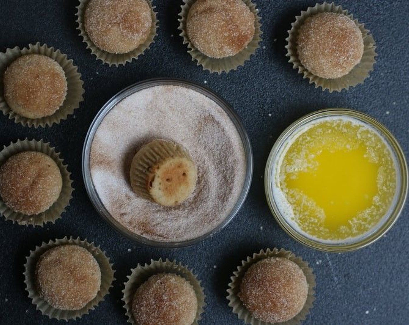 step 9 In a separate bowl, stir together the Simply Organic Cinnamon, Ground (1/2 tsp) and Granulated Sugar (1/2 cup) until well combined. Dip each mini-muffin upside down into the Butter (4 Tbsp), coating the top evenly. Immediately dip and roll in the cinnamon sugar mixture.