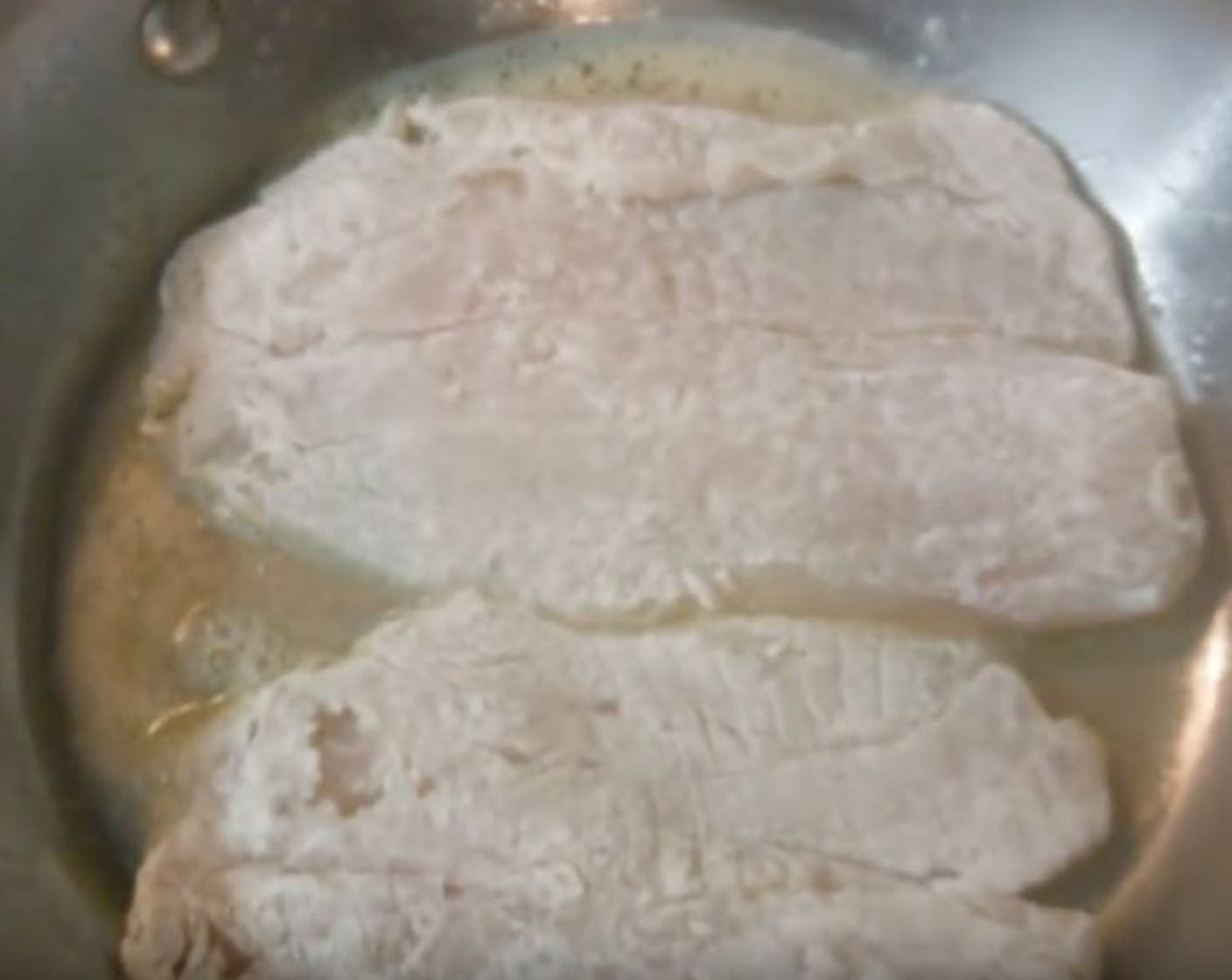 step 3 Into a skillet over medium heat, add half the Salted Butter (2 Tbsp) and half the Vegetable Oil (1 Tbsp). Once warm and bubbling, add the first two fillets flat side down. Cook for 4 minutes on each side.