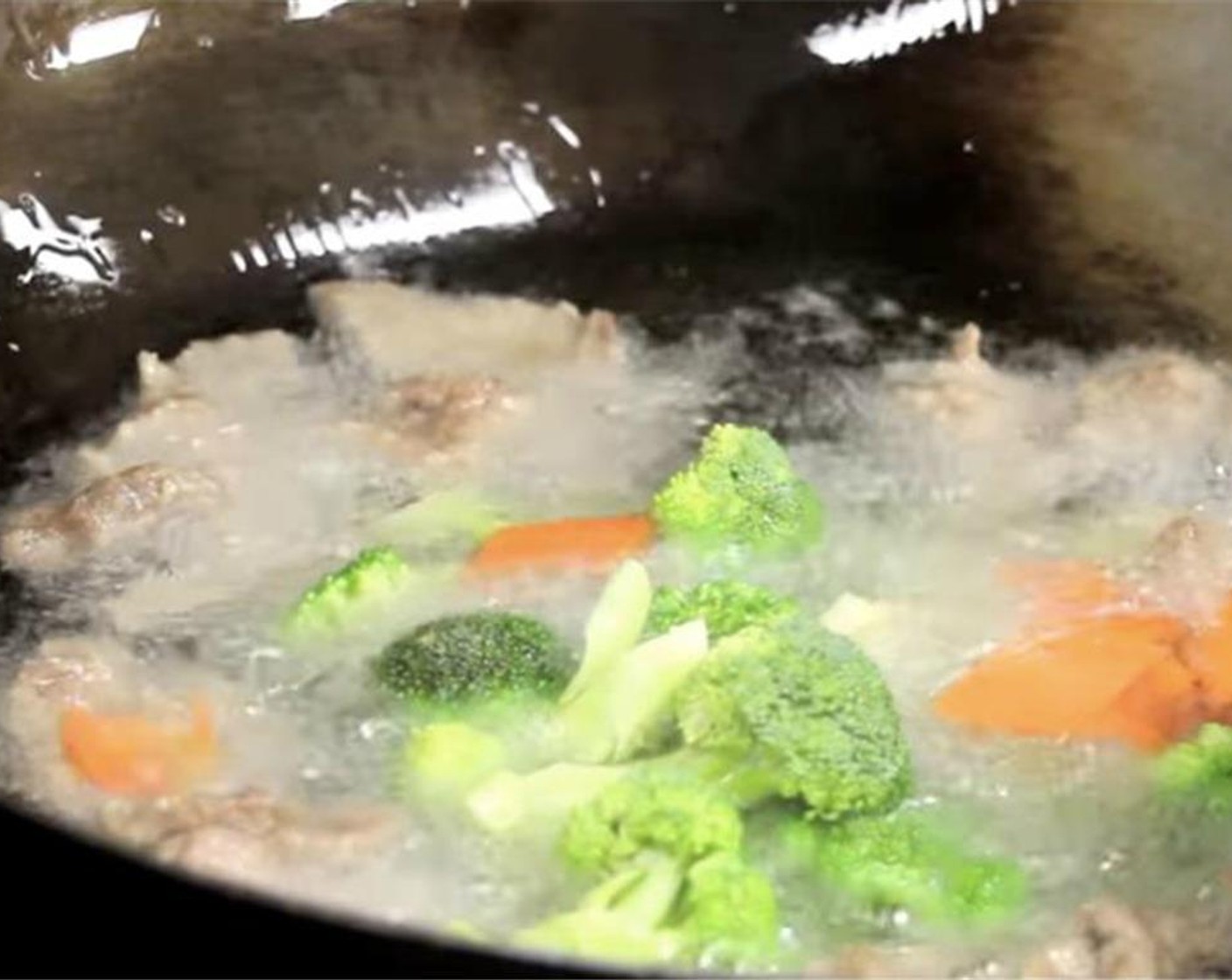 step 11 In a wok or pan, heat up some Vegetable Oil (as needed). Once it reaches 250 degrees F (120 degrees C), fry the beef. Then continue to heat the oil to 325 degrees F (160 degrees C). Move the meat around to get an even cook. Add the broccoli and carrot for 20 seconds. Strain from wok.
