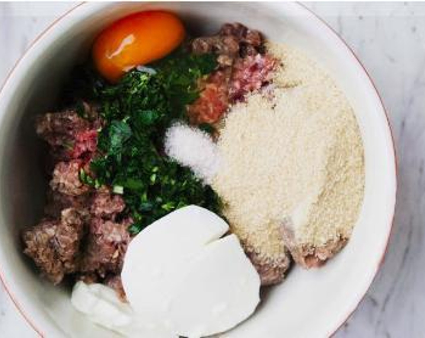 step 2 In a bowl combine Ground Beef (1.1 lb), Fresh Rosemary (1 Tbsp), Egg (1), Greek Yogurt (1/3 cup), Breadcrumbs (1/3 cup), Salt (1 tsp) and Ground Black Pepper (1/4 tsp).