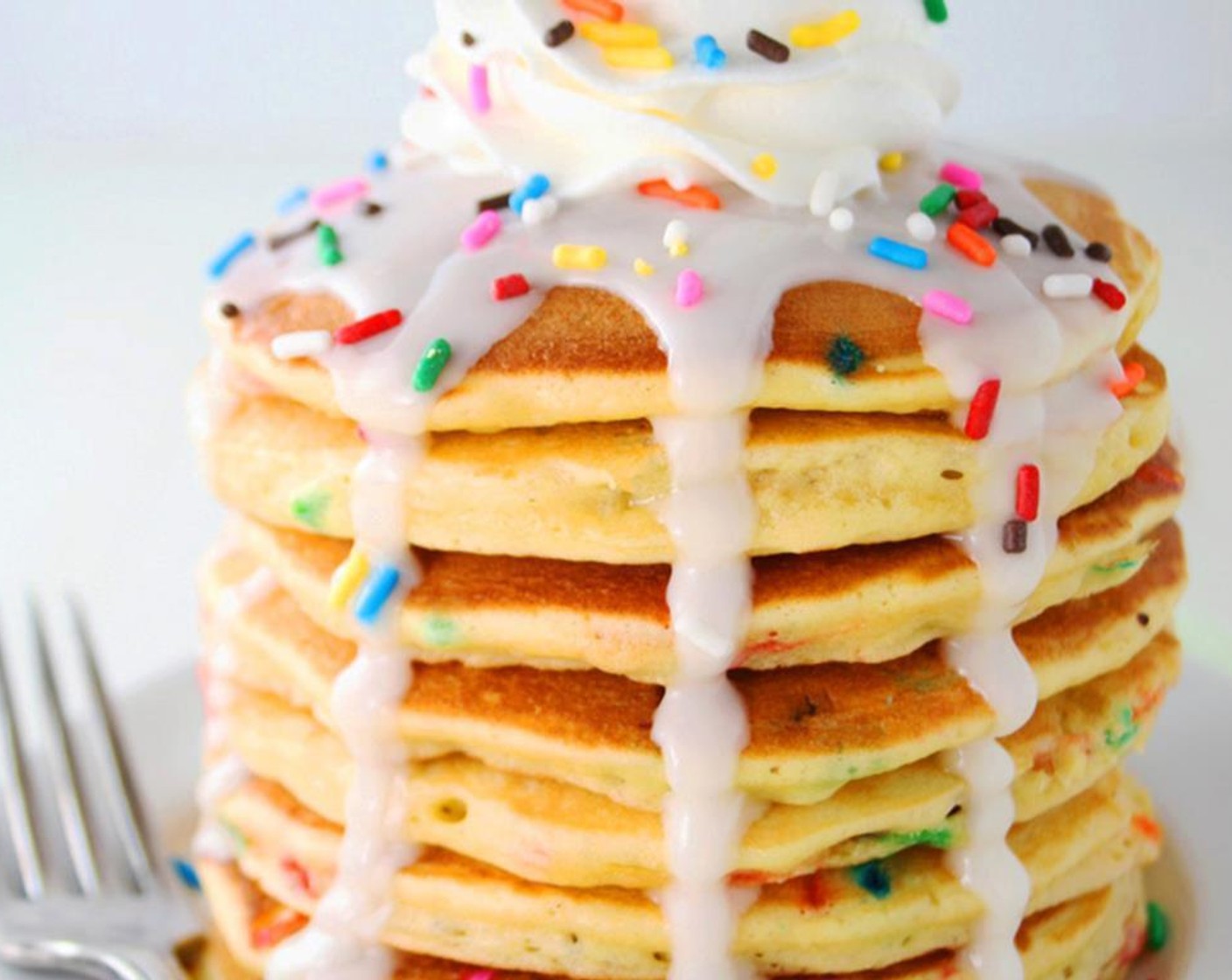 step 5 Serve pancakes with vanilla glaze, Sprinkles (to taste), Whipped Topping (to taste), and Cherries (to taste). Enjoy!