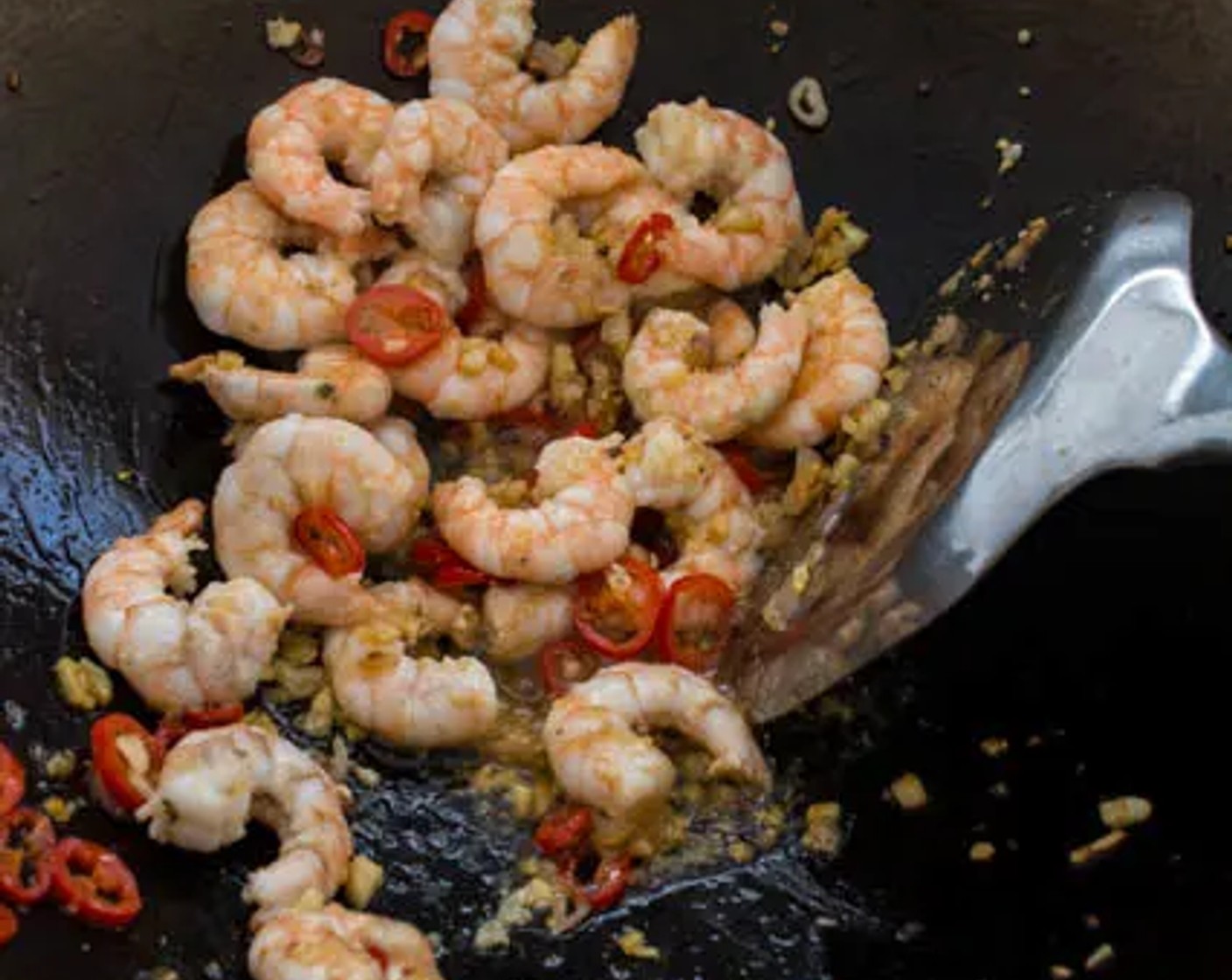 step 2 When the garlic and shallots start to turn slightly brown, add Red Chili Pepper (1) to the wok. Add Medium Shrimp (10), then stir-fry until slightly opaque.