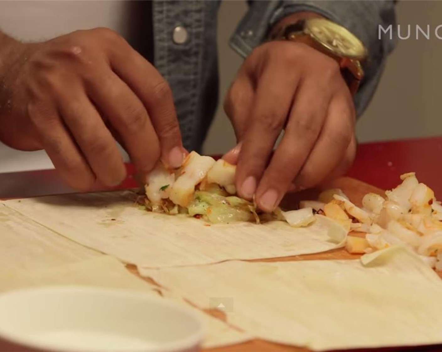 step 10 Next, make the egg roll. Take one sheet of the Wonton Wrappers (1 pckg) and add two pinches of braised cabbage onto one corner of the sheet. Add some of the lardons and shrimp on top (but don't overstuff the wrapper).