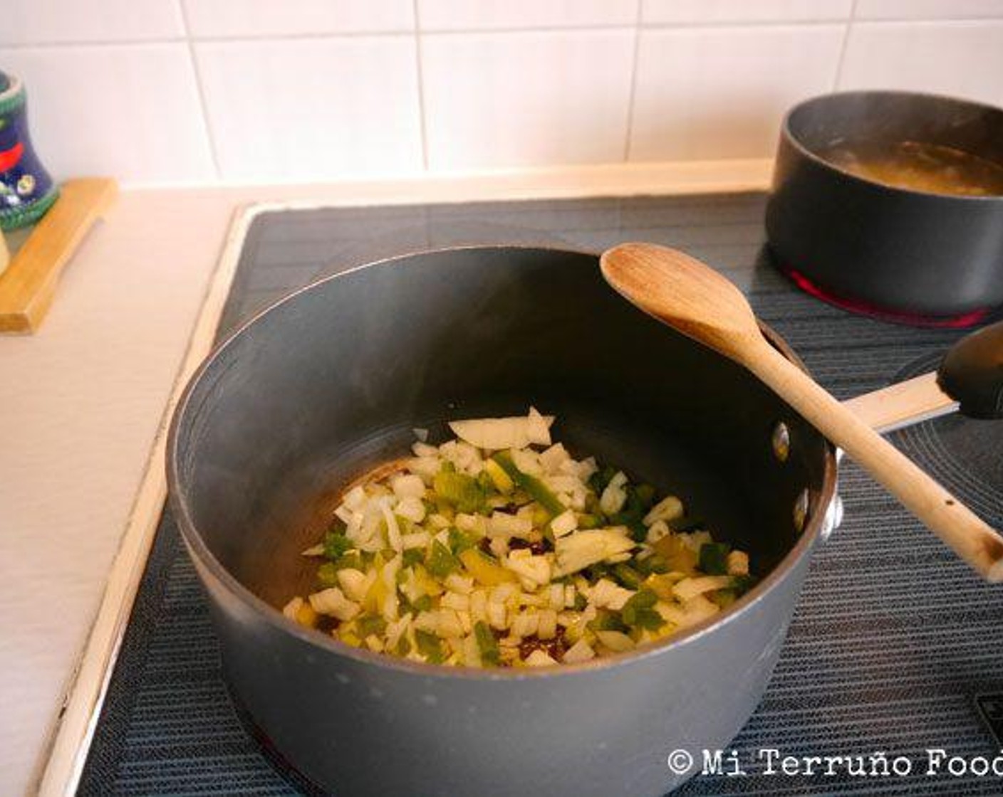 step 5 In a warm pan, add the Extra-Virgin Olive Oil (3 Tbsp), Salt (to taste), onion, Garlic (3 cloves), and green bell pepper and leave to cook for approximately 5 minutes until soft.